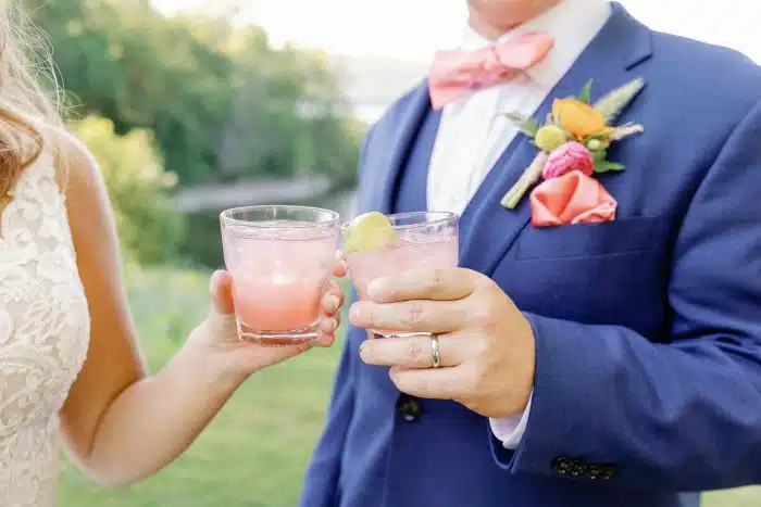 Wedding couple cheers with signature cocktail