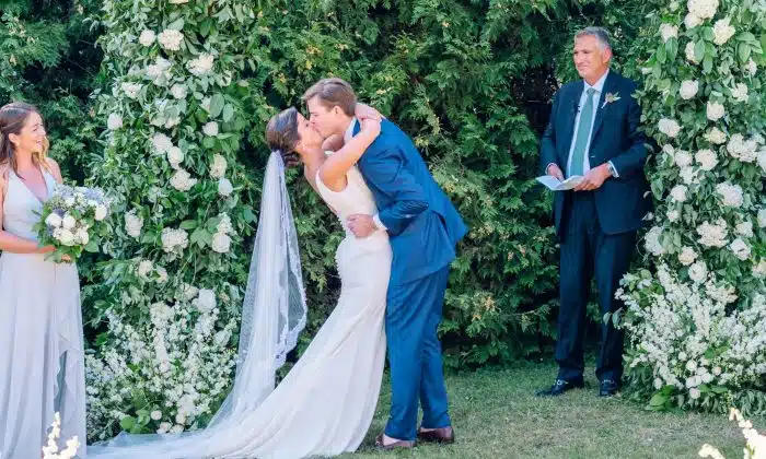 A bride and groom kissing at their wedding ceremony