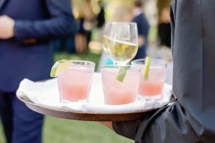 A server carrying drinks around an event