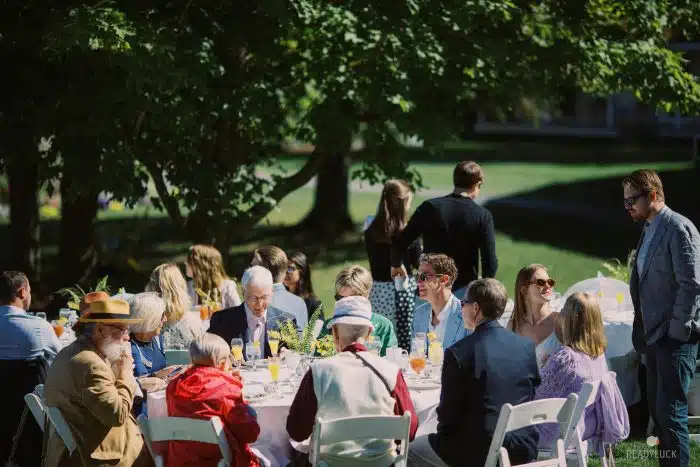 A table of people chatting at an event on the lodge lawn