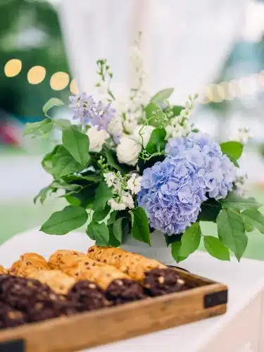 Churros set out for brunch next to a flower arrangement