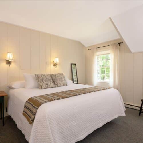 A bedroom with a queen bed in one of the accommodations