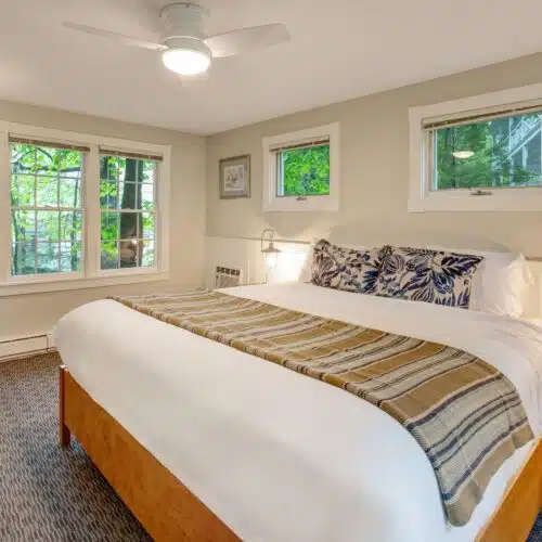 A bedroom with a king bed in one of the accommodations