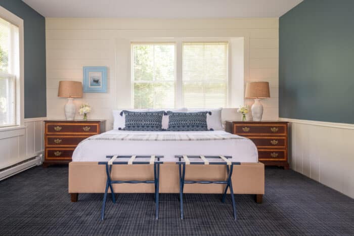 A bedroom with a king bed in one of the accommodations