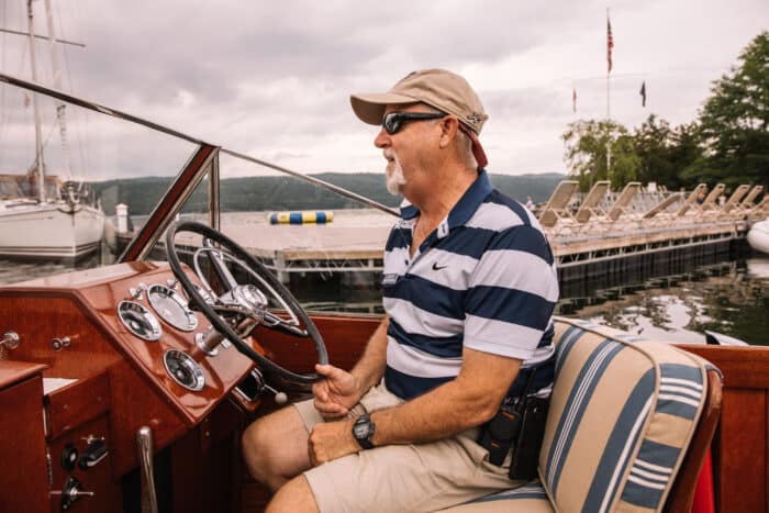 A waterfront team member driving one of the boats
