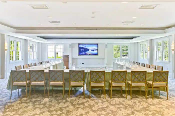 Horseshoe meeting table set up with podium in the Club Room