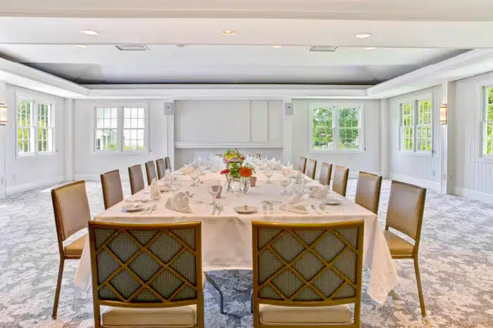 Long family style table set for a meal in the Club Room
