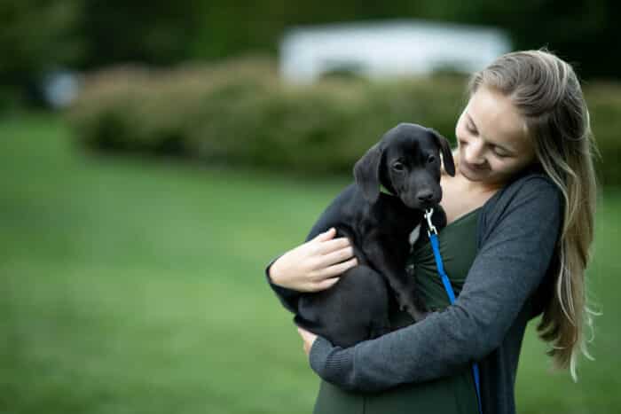 A girl holding a puppy