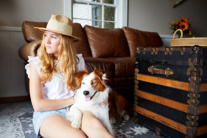 A dog and a girl sitting in one of the cottages