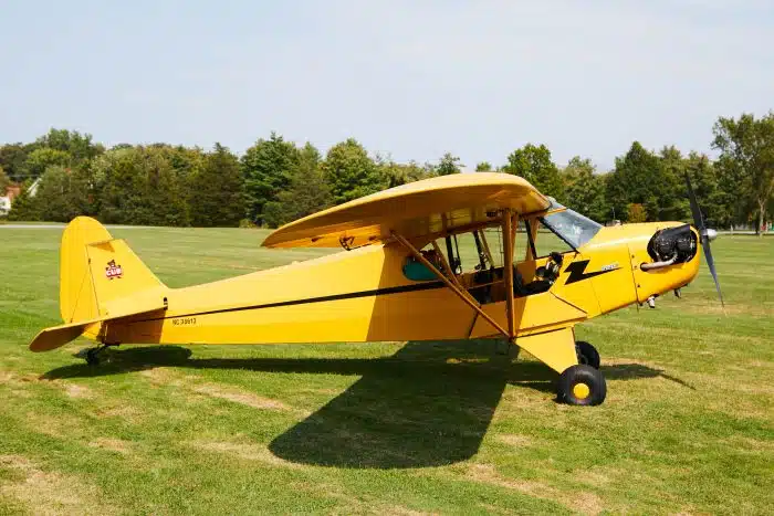 A yellow plane on the air strip