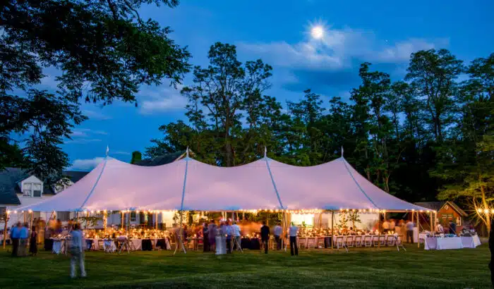 A wedding reception under a wedding tent