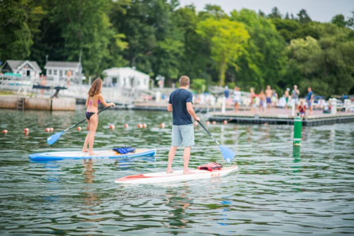 Woman and Man on paddle boats in harbor on Lake Champlain.