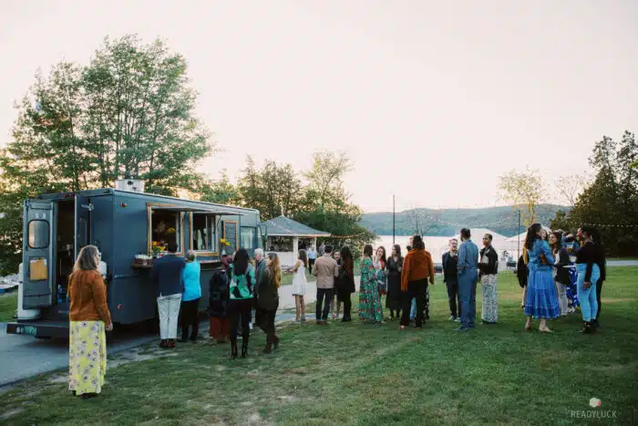 A group of people gathered by the food truck