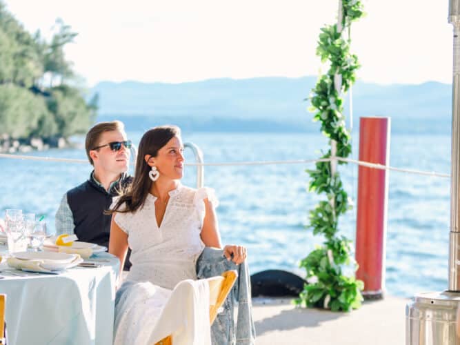 Bride and groom listens to speeches on the North Dock for their wedding reception