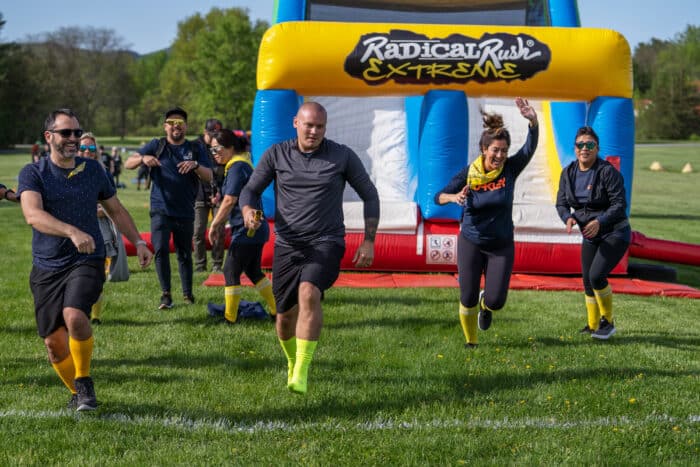 Group runs over the finish line at an obstacle course race