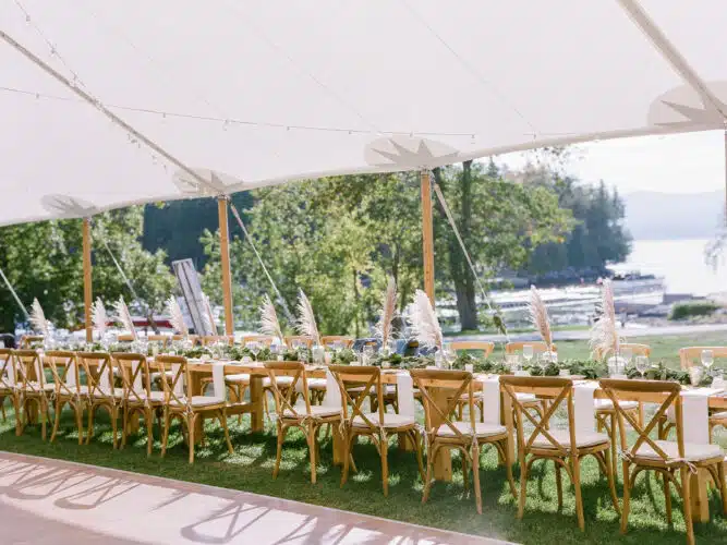 A wedding tent near the waterfront set up for a wedding reception