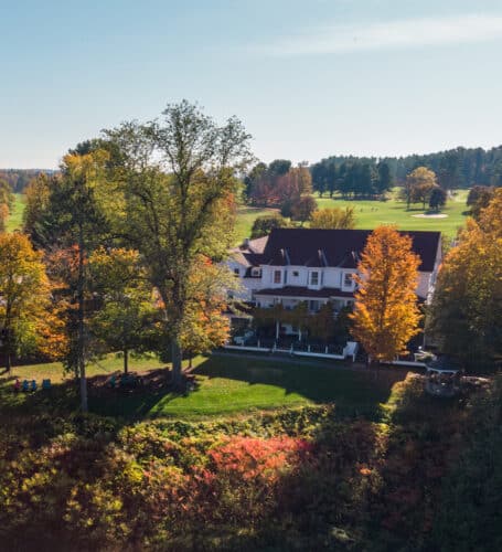 an aerial view of the main lodge during fall